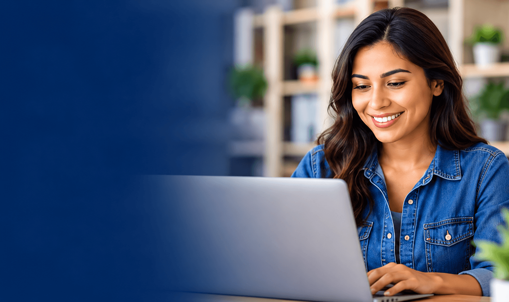 Smiling woman working on her laptop at home